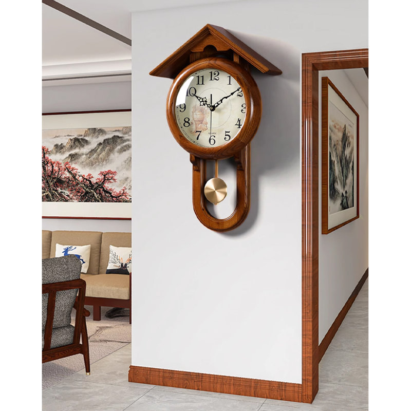 Vintage solid wood wall clock with a roof-shaped top and a metal pendulum