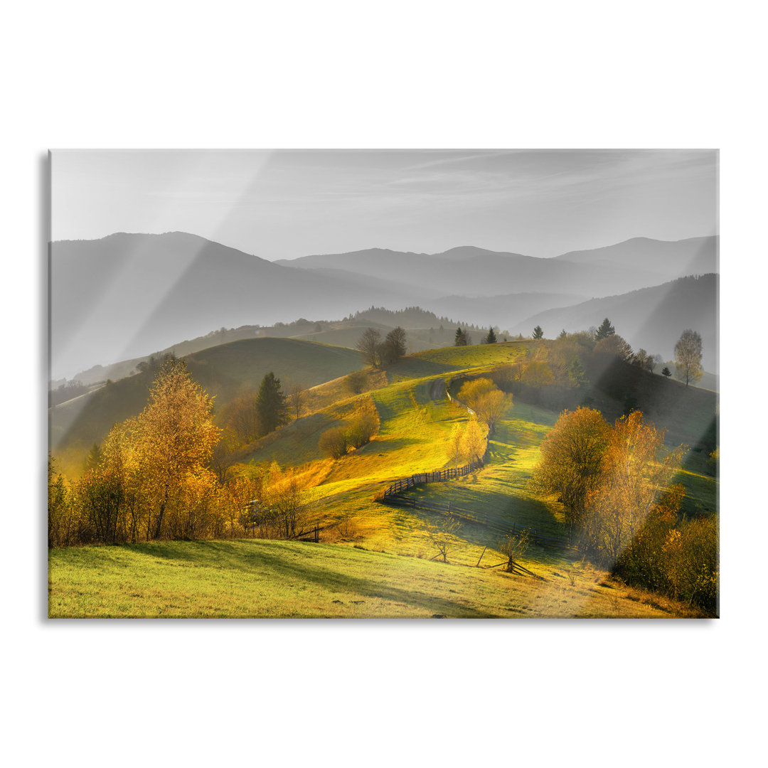 Glasbild Hügelige Herbstlandschaft bei Sonnenuntergang