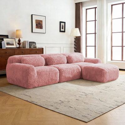 Canapé modulaire en L en peluche avec zones compressées, rembourré de mousse haute densité 32D, comprenant un repose-pieds amovible.