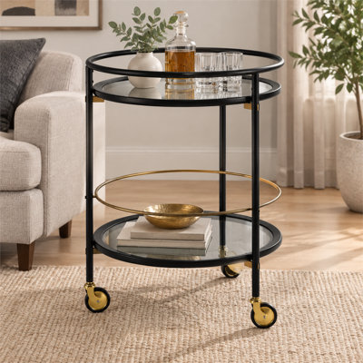 A modern round mobile bar cart featuring a black finish, tempered glass shelves, and gold accents that add a touch of sophistication and elegance.