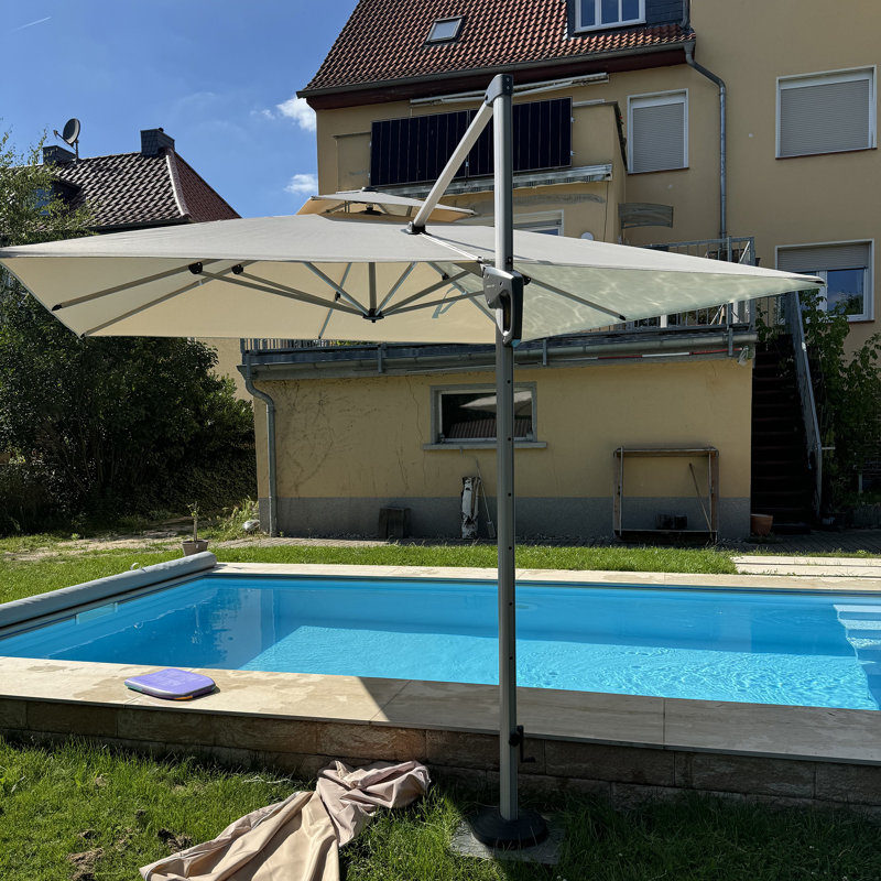 Shalonte 132'' Cantilever Umbrella with Crank Lift Counter Weights with Base in Ground, Beige