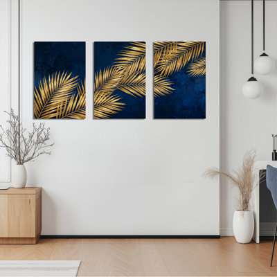 Ensemble de 3 tableaux sur toile tendue, motif de feuilles de palmier dorées sur fond bleu marine