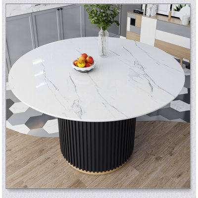 Table de salle à manger ronde en faux marbre avec piètement en métal ondulé pour des réceptions élégantes dans la cuisine et la salle à manger.