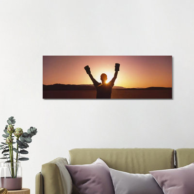 Silhouette Of A Person Wearing Boxing Gloves In A Desert At Dusk - Wrapped Canvas Panoramic Print