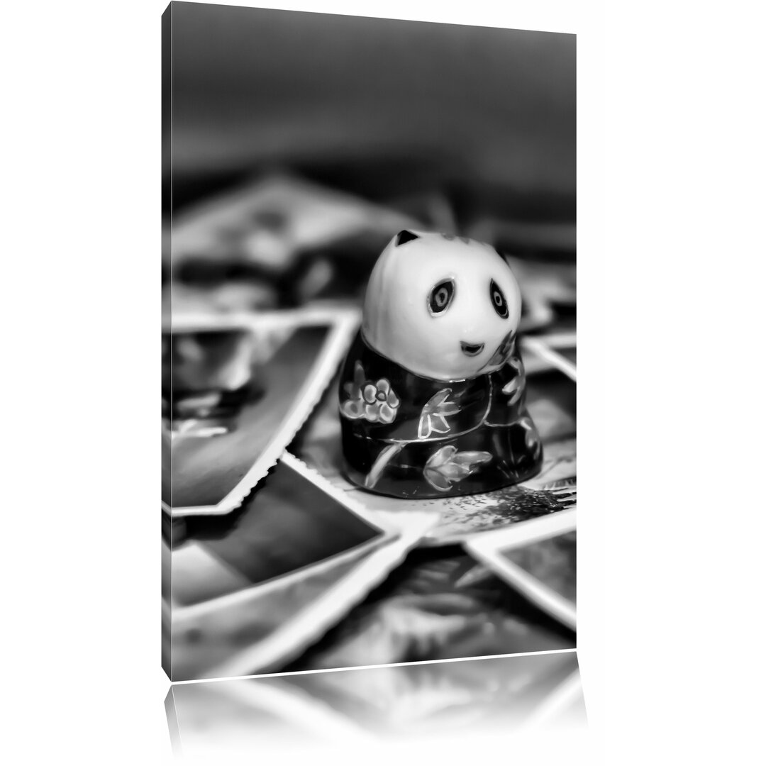 Leinwandbild Panda Figur zwischen Fotografien in Monochrom