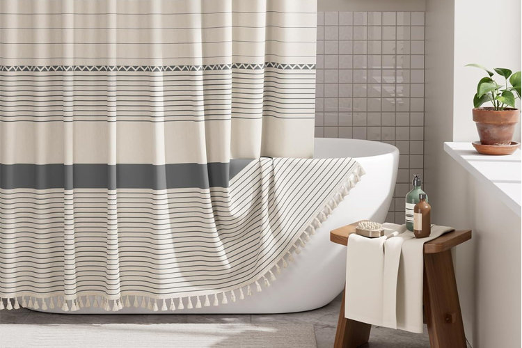 striped shower curtain around a freestanding bathtub