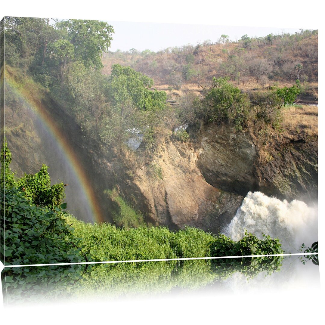 Leinwandbild Regenbogen über Wasserfall