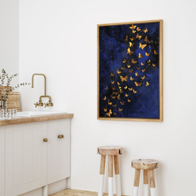 Gold Butterfly Against Dark Blue Background