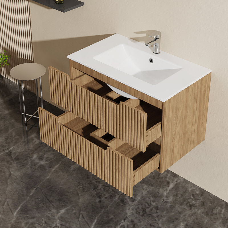 Meuble-lavabo mural avec lavabo et système de fermeture en douceur, offrant beaucoup de rangement et une conception moderne pour une salle de bain sans encombrement