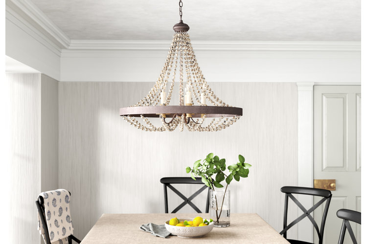 coastal dining room with a beaded empire chandelier
