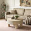 Table basse ronde avec plateau rabattable et compartiment de rangement caché