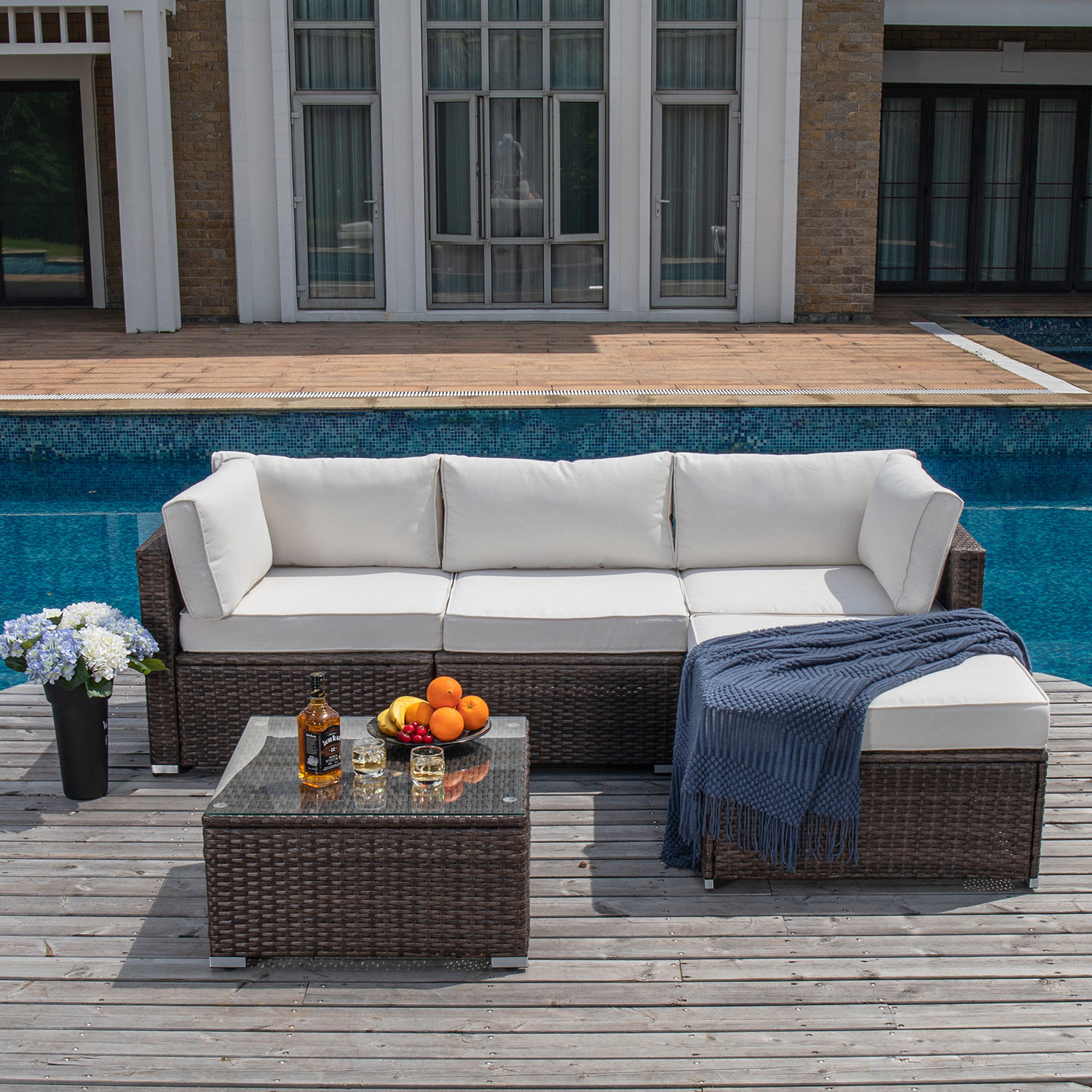 https://assets.wfcdn.com/im/05487908/compr-r85/2066/206692627/shivangi-5-piece-outdoor-furniture-set-warm-gray-wicker-sectional-sofa-w-thick-cushions-glass-coffee-table-1-ottoman-3-floral-fantasy-pillows.jpg