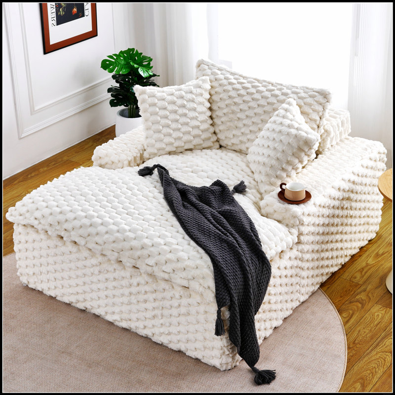 Canapé polyvalent de 130 cm d'épaisseur, confortable et doté de coussins et d'un dossier, idéal pour se détendre dans le salon ou la chambre.