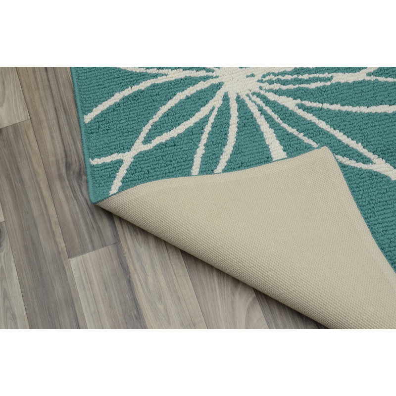 Tapis sarcelle / ivoire touffeté à motif floral Tihiri