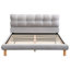 Confortable lit double gris avec tête de lit distinctive en forme de biscuit et structure stable en chenille