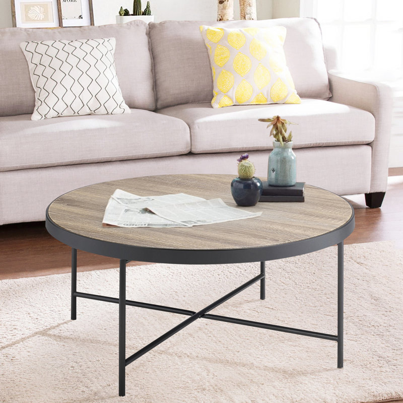 Table basse ronde avec bordure en métal, beaucoup d'espace au fini industriel gris et noir, noir, surface en bois