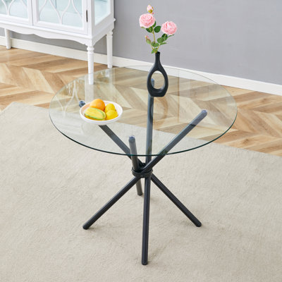 Une table ronde circulaire en verre trempé transparent d'un diamètre de 36,6 pouces, avec des pieds en métal rassemblés en forme d'anneau. Le verre du bureau mesure 0,3 pouce d'épaisseur.