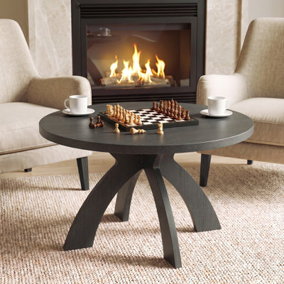 Table basse ronde moderne en bois avec pieds croisés courbés