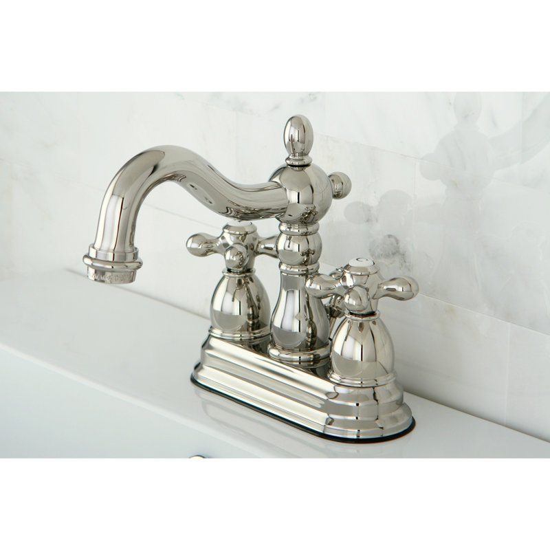 Robinet de salle de bain central à deux poignées et 3 trous à fixation sur le comptoir de 4 po avec bonde escamotable en plastique Kingston Brass Heritage