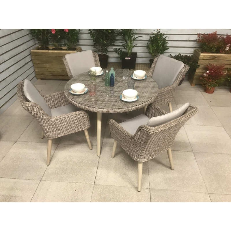 Deanna 4 - Person Wicker Patio Dining Set with Round Table , Cushions Included