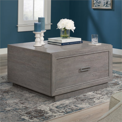 Table basse moderne aspect béton, ton brun, avec tiroir et rangement ouvert