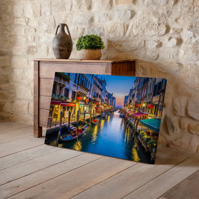 Canvas A Serene Evening Scene In A Venetian Canal Illuminated By Wall Art Soft Warm Light From Vintage Lanterns And Glowing Red Canvas Wall Art