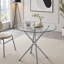 Table de salle à manger ronde en verre avec pieds en métal en forme d'anneau-133409247