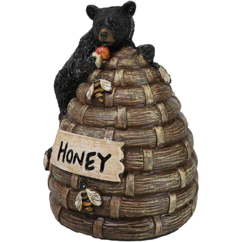 Figurine d'ours noir rustique grimpant sur une ruche au miel avec des bourdons