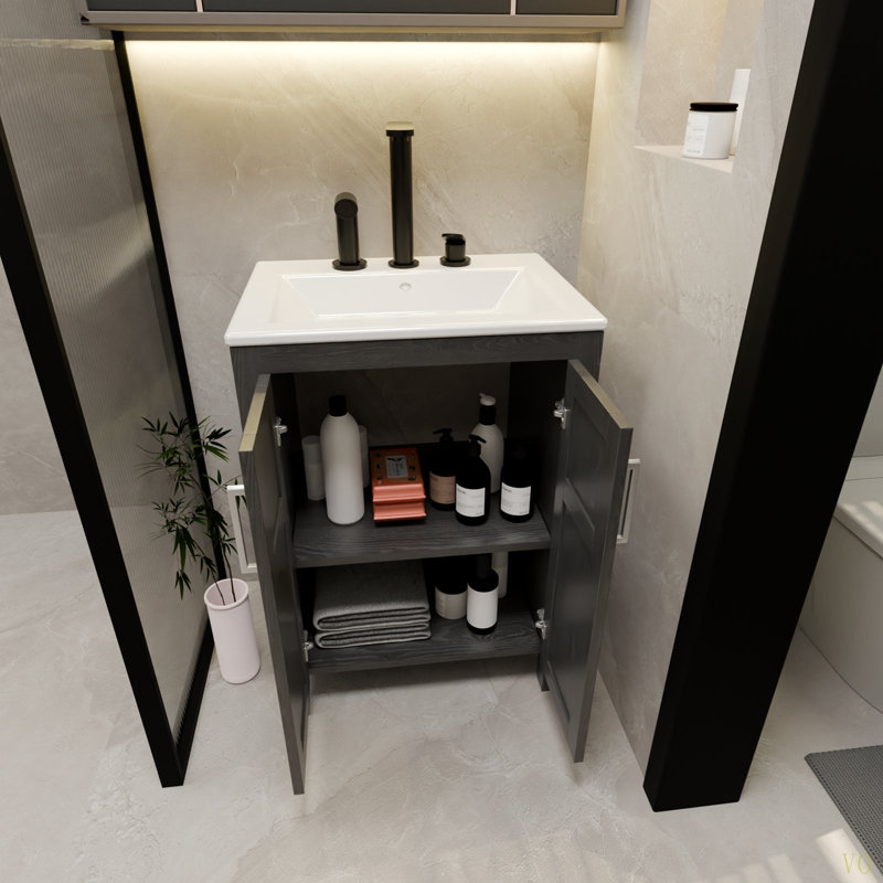 Une armoire de salle de bain de 24 pouces, jumelée à un lavabo en céramique, possède un design moderne et est faite de matériaux imperméables et durables.