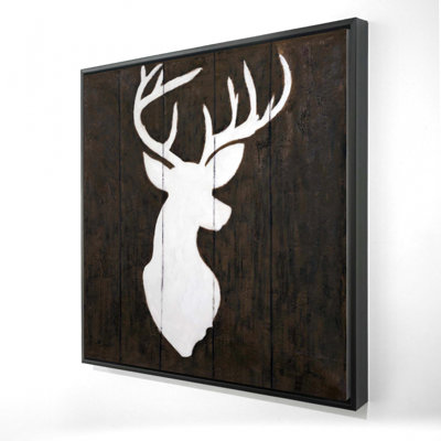 "Silhouette blanche d'un cerf sur bois"