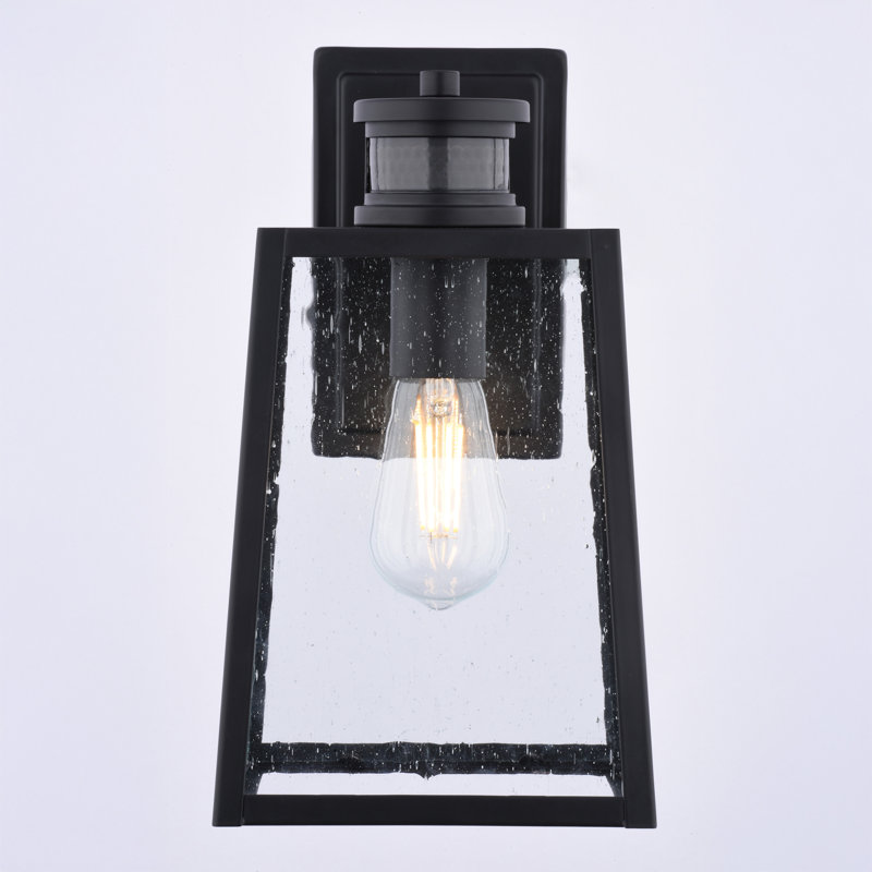  Sutton 12.25 in. H 1-Light Matte Black Contemporary Motion Sensor Dusk to Dawn Outdoor Wall Light, Clear Seeded Glass, LED Compatible, Use for Exterior Porch Patio Front Door or Garage
