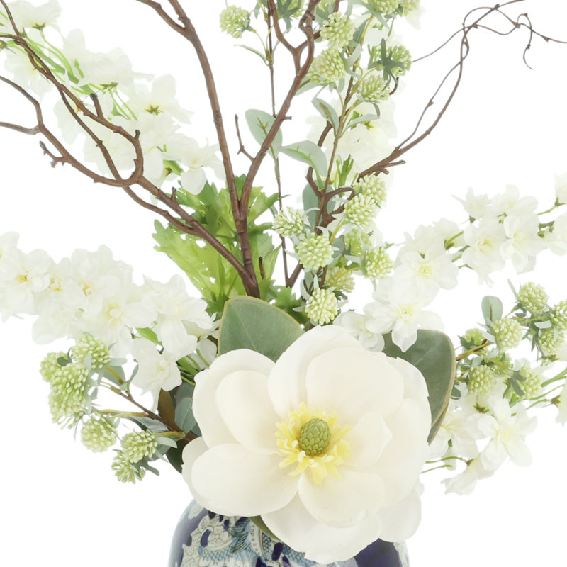 Magnolia and Delphinium Arrangement in a Decorative Ceramic Vase