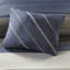 Twin Bedroom With Blue Grey Striped Sheets And Comforter & Round Pillow