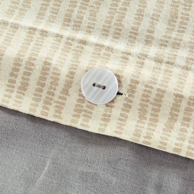 Literie en coton avec boutons cachés et détails pompon