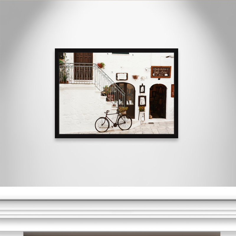 La Bottega D'Arte by Bogdan Dada, 26.5" H x 36.5" W x 0.75" D, Black Framed