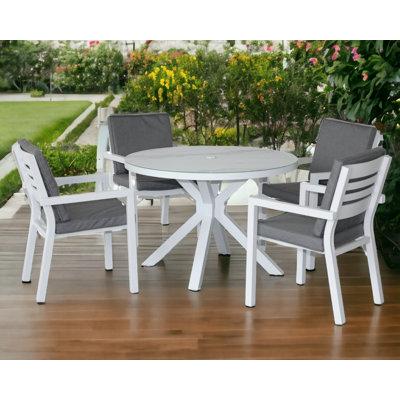 Luxton 4 - Person Patio Dining Set Round Table with Cushions Included