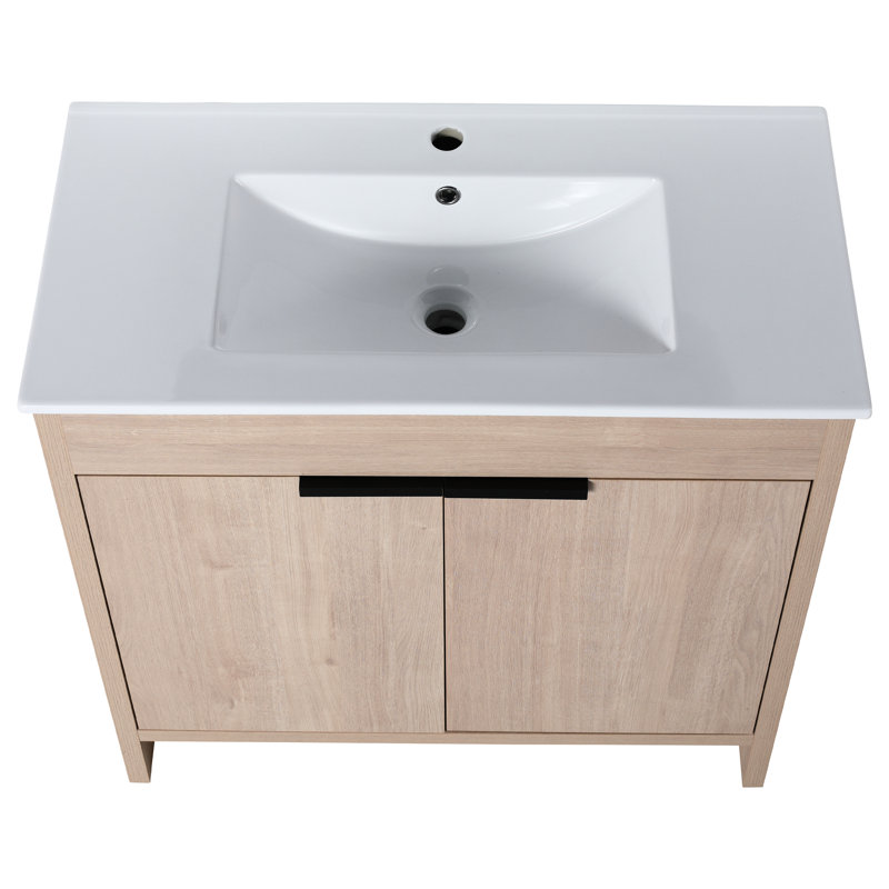 Coffre de salle de bain autoportant 36 pouces. Évier en céramique et 2 portes d'armoire à fermeture en douceur. Soupçon de chêne brut. Tablette réglable. Poignées en métal. Ensemble de meuble-lavabo Hardy Scintillant distinctement.