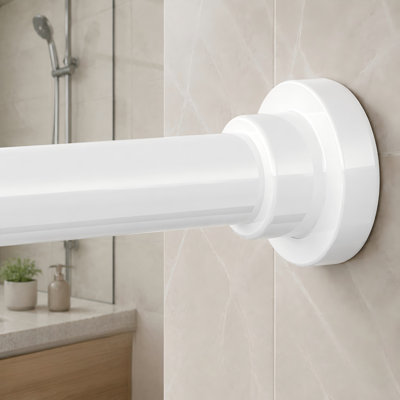 A white heavy-duty spring-tension shower rod adjustable from 28-74 inch with a 1" diameter; the no-drill, non-slip, no-rust design is intended for bathrooms and shower stalls.