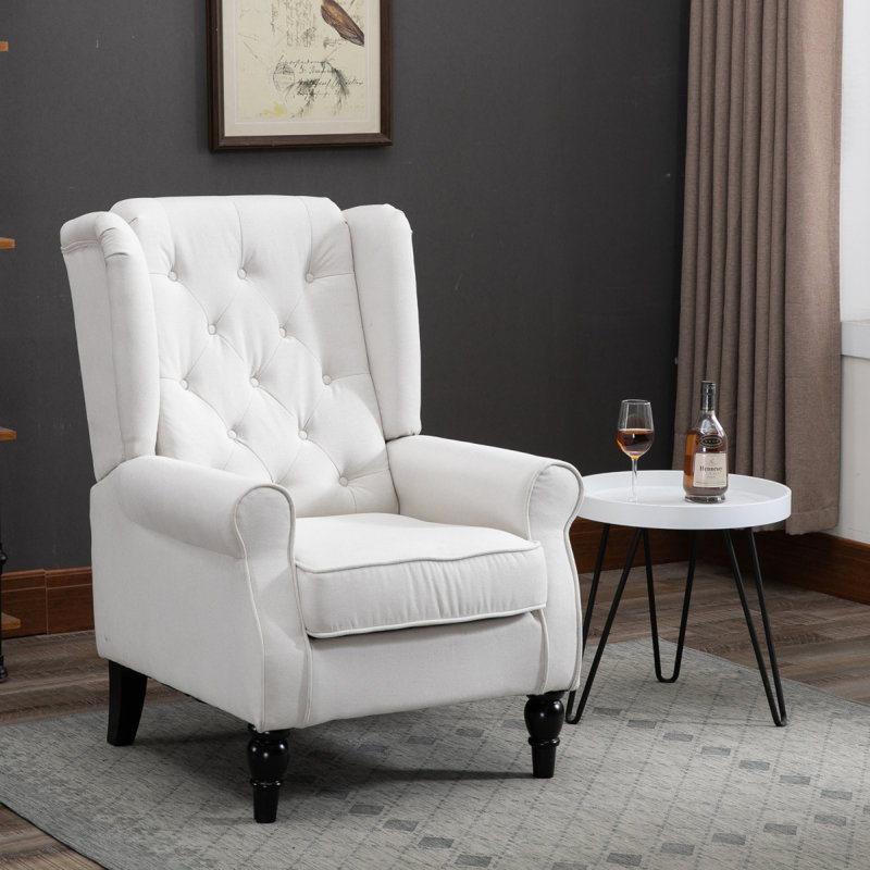 Fauteuil d'appoint capitonné à boutons avec haut dossier à oreilles, accoudoirs rembourrés arrondis et siège rembourré épais