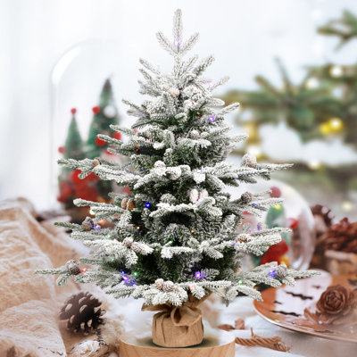 Sapin de Noël artificiel de table floqué et préilluminé avec lumières DEL bicolores et base en toile de jute