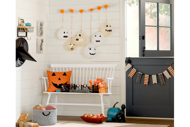 Halloween styled entryway with snacks to hand out to trick-or-treaters