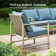 Ensemble de mobilier d'extérieur en osier rétro avec coussins bleus et table basse
