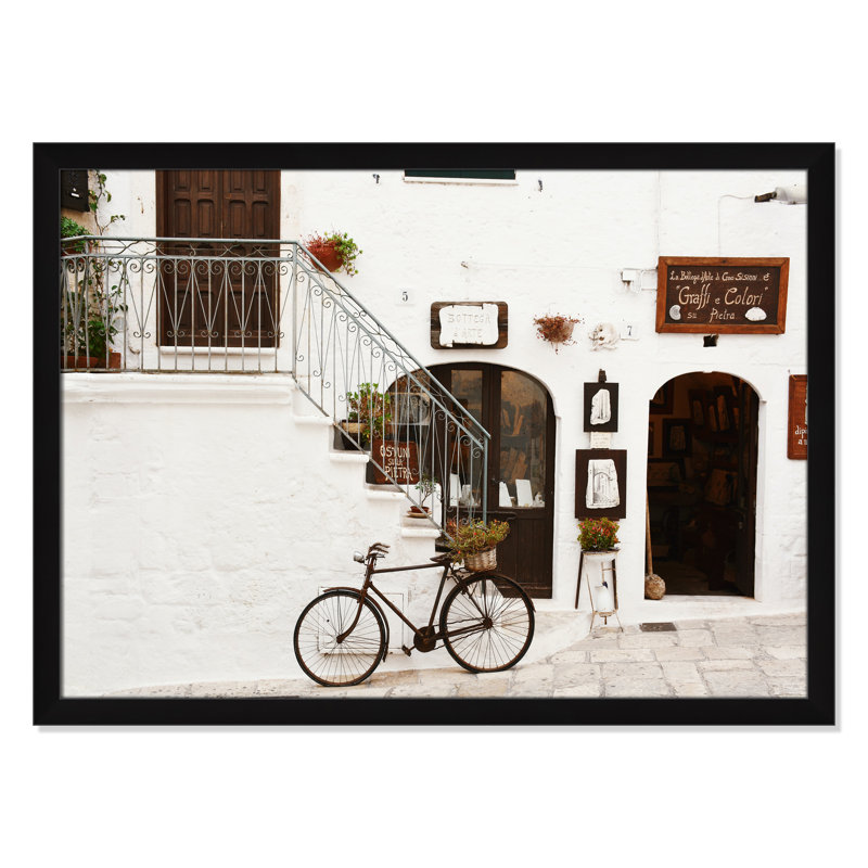 La Bottega D'Arte by Bogdan Dada, 26.5" H x 36.5" W x 0.75" D, Black Framed