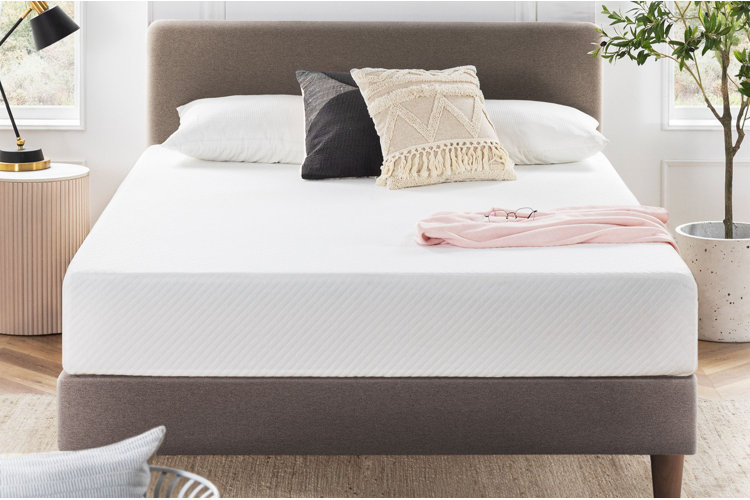 modern upholstered bed frame with thick white mattress