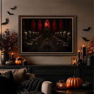 Squelettes gothiques assis à une longue table avec une toile rouge d'Halloween