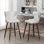 Mid-Century moderne 2. Similicuir avec tissu semblable au suède. Dossier à boutons et garniture de tête de clou courbée. Repose-pieds conique en bois massif au fini noyer massif et pieds dorés. Taille: l 19,75 po x P 21,5 po