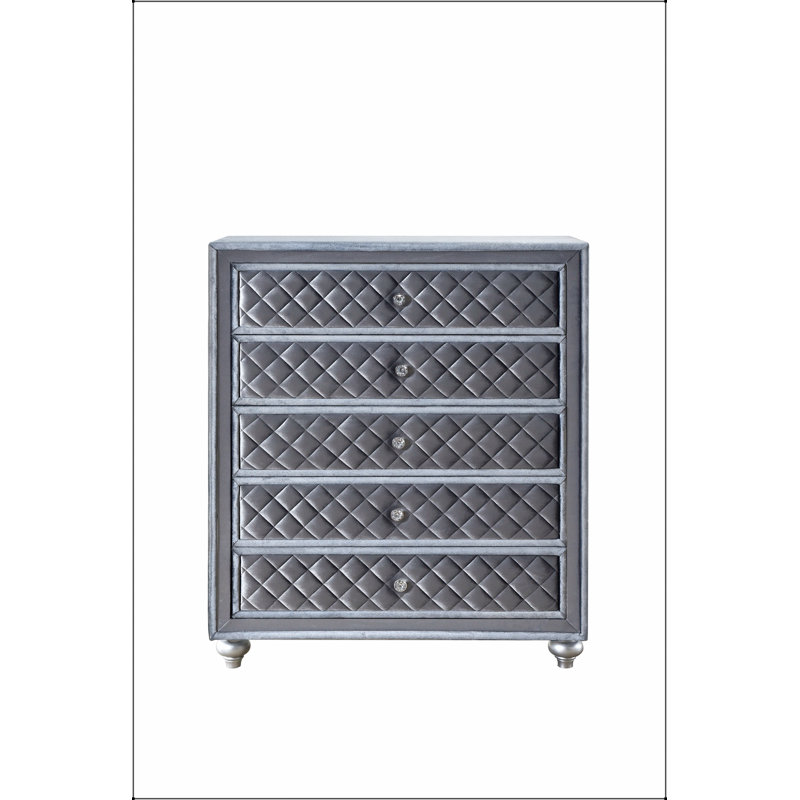 Commode 5 tiroirs Glam avec façades capitonnées en velours et boutons en faux cristal pour un rangement élégant