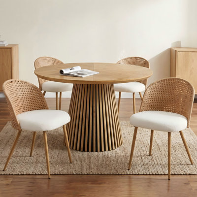 A Set Of Four Brown Rattan Dining Chairs, Blending Medieval And Bohemian Styles, With Beige Sponge Cushions, Suitable For Modern Restaurant Kitchens.