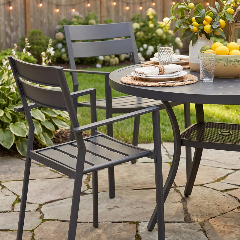 Eidanas 4-Person Outdoor Dining Set with 40.6" Round Dining Table and 4 Stackable Chairs, Black