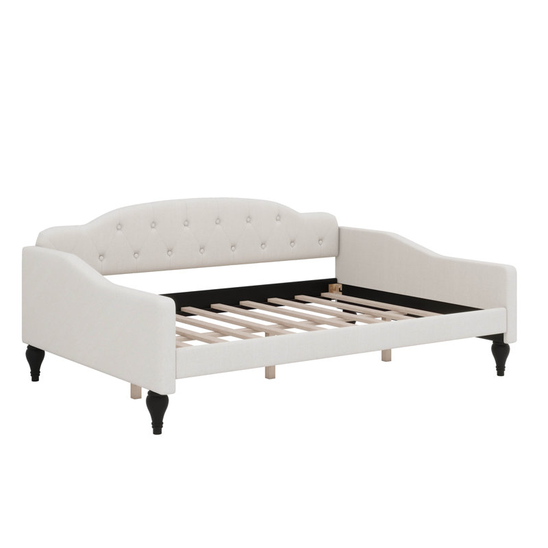 A Full-Size Upholstered Daybed With Tufted Detailing